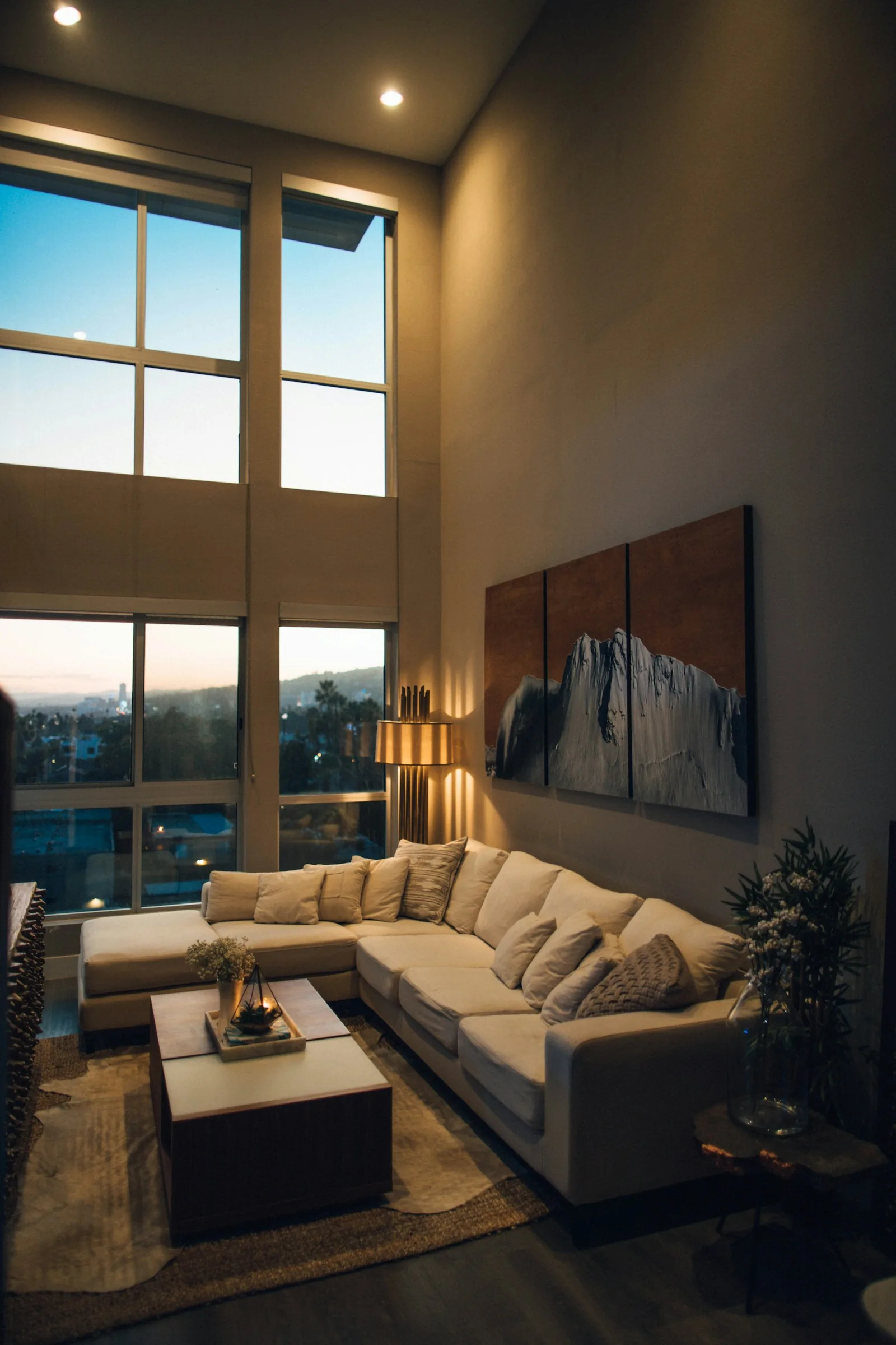 Finished living room with tall windows and comfortable seating