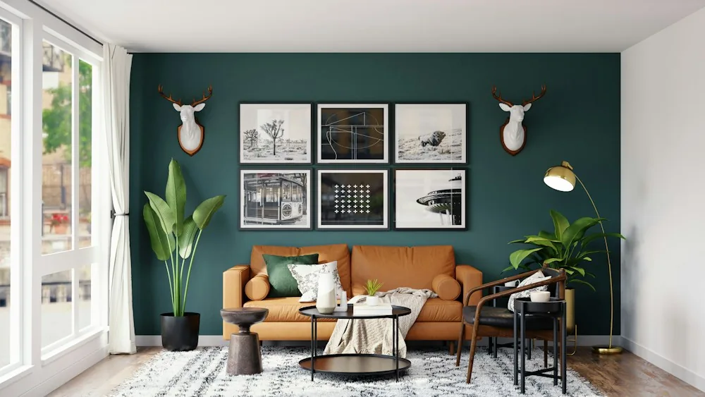 Living room with a deep green painted wall and tan sofa